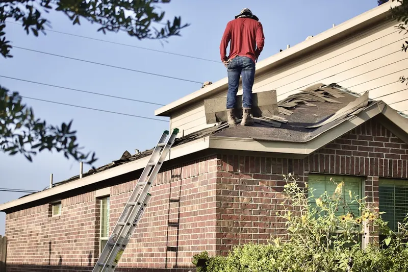 Professional roofer working on a residential roof in North Fairmount